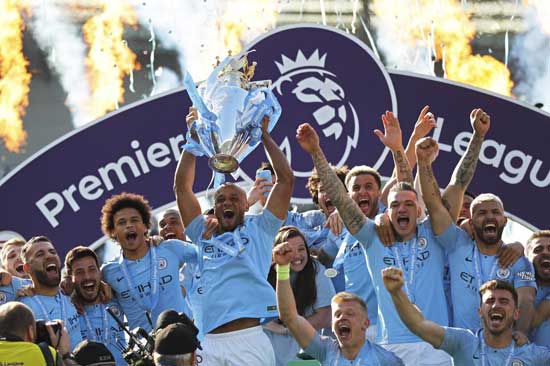 Manchester City's Vincent Kompany lifts the English Premier League trophy after the English Premier League soccer match between Brighton and Manchester City at the AMEX Stadium in Brighton, England, Sunday, May 12, 2019. Manchester City defeated Brighton 4-1 to win the championship. (AP Photo/Frank Augstein)