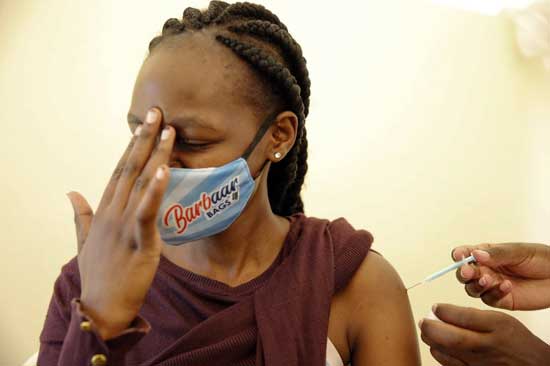 In this April 8, 2021, file photo, a woman at Kenyatta National Hospital in Nairobi, Kenya, receives a dose of AstraZeneca COVID-19 vaccine manufactured by the Serum Institute of India and provided through the global COVAX initiative. COVAX is providing vaccines to countries lacking the clout to negotiate on their own for scarce supplies, but in the past two weeks only 2 million doses have been cleared for shipment to 92 countries. (AP Photo/Brian Inganga, File)