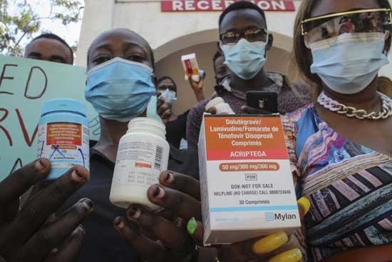 Protesters hold empty containers of anti-retroviral (ARV) medicines during a demonstration over shortages of ARVs, organized by people living with HIV or AIDS, sex-workers, members of the LGBT community, and their supporters, in the port city of Mombasa, Kenya, Thursday, April 22, 2021. Kenyans living with HIV say their lives are in danger due to a shortage of anti-retroviral drugs donated by the United States amid a dispute between the U.S. aid agency and the Kenyan government. (AP Photo)