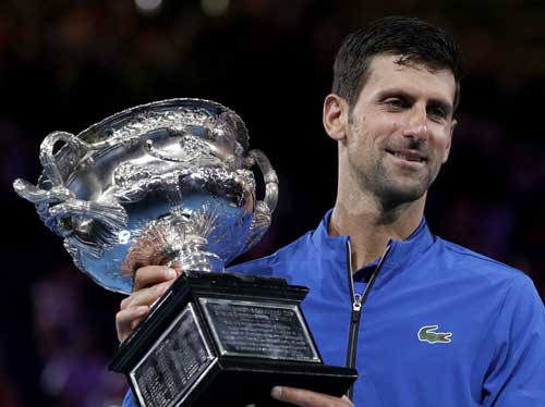 Serbia's Novak Djokovic holds his trophy after defeating Spain's Rafael Nadal in the men's singles final at the Australian Open tennis championships in Melbourne, Australia, Sunday, Jan. 27, 2019. (AP Photo/Aaron Favila)