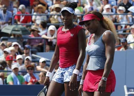 Venus (l.) and Serena Williams are called 'the Williams brothers' by the head of the Russian Tennis Federation who also referred to the American stars as 'scary.'