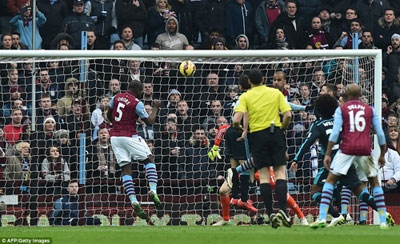 Okore (left) waits for the ball before heading it past Chelsea stopper Thibaut Courtois to net Villa's equaliser on Saturday