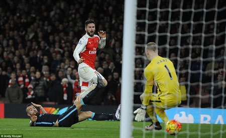 Olivier Giroud watches on excitedly as his powerful shot coasts through the legs of a helpless Joe Hart in the City goal to double Arsenal's lead.