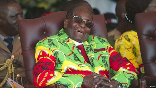FILE - Zimbabwean President Robert Mugabe smiles during a youth rally in Marondera about 100 kilometers east of Harare.