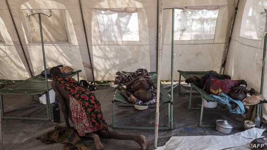 FILE - Patients suffering from cholera receive treatment inside a tent converted into a temporary field hospital near the remote village of Dor, Sudan, April 28, 2017.