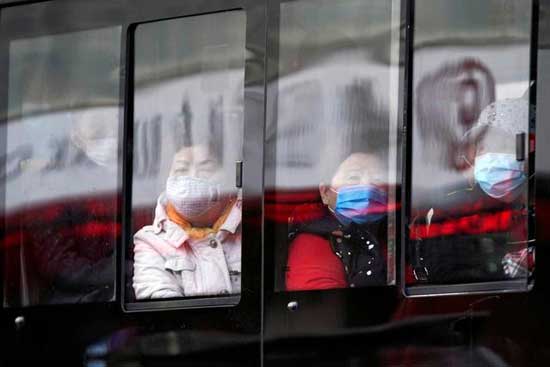 People wear protective face masks on a bus following an outbreak of coronavirus disease (COVID-19), in downtown Shanghai, China March 16, 2020. REUTERS/Aly Song