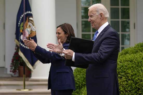 President Joe Biden claps with Vice President Kamala Harris after speaking on updated guidance on face mask mandates and COVID-19 response, in the Rose Garden of the White House, Thursday, May 13, 2021, in Washington. (AP Photo/Evan Vucci)