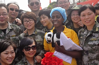 Ebola patient Beatrice Yardolo, center, surrounded by Chinese military health workers.
