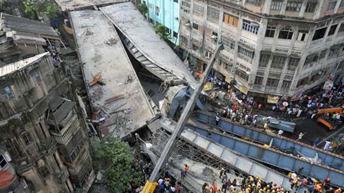Locals and rescue workers clear the rubbles of a partially collapsed overpass in Kolkata, Thursday