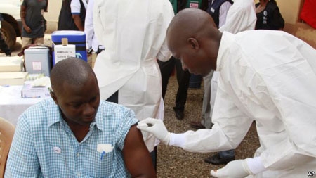 File image: A health worker prepares to inject a man with an Ebola vaccine in Conakry, Guinea, March 7, 2015.